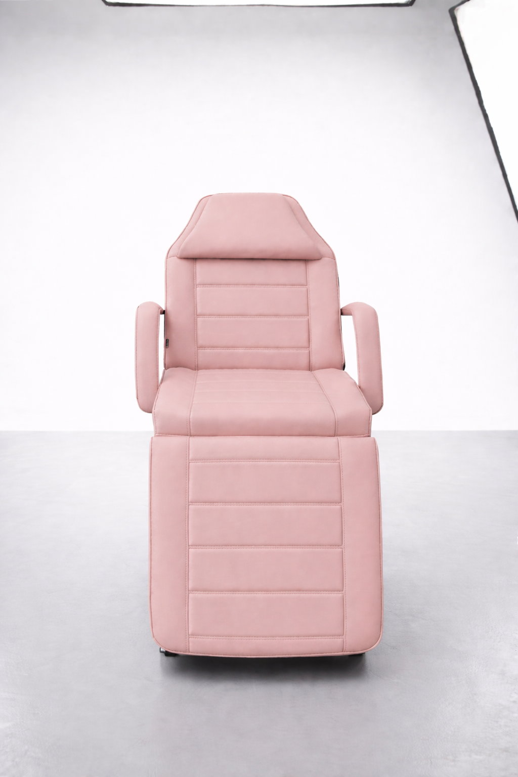 Modern beauty treatment bed with segmented cushioning, adjustable positions and durable pink vinyl finish