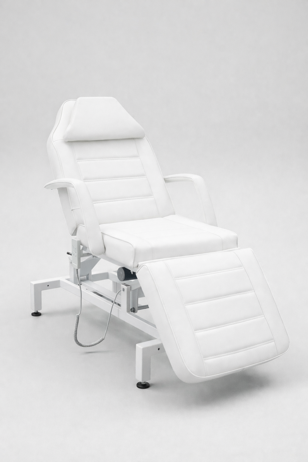 Adjustable salon and clinic bed in white finish with segmented cushioning for comfort and versatility