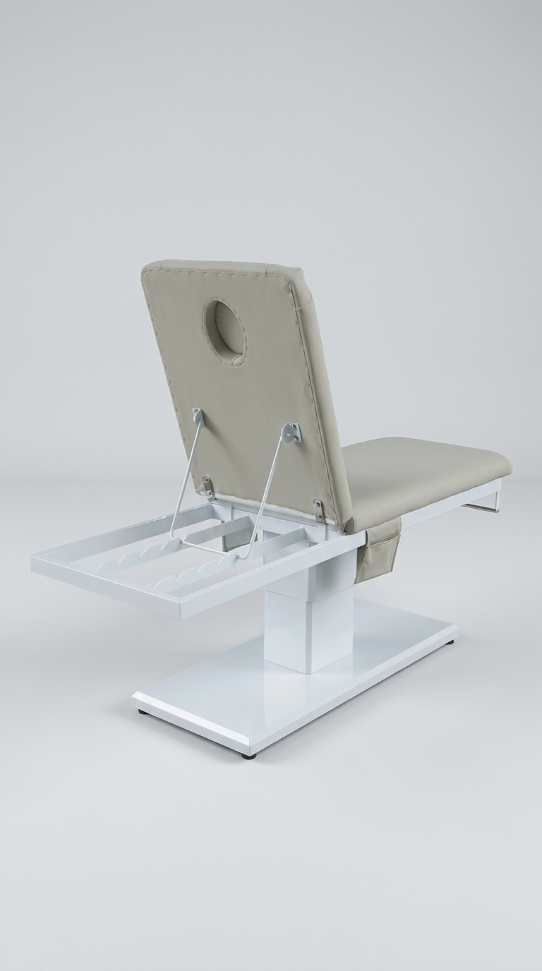 Sleek medical spa treatment bed in grey vinyl with sturdy white pedestal base and integrated paper roll holder