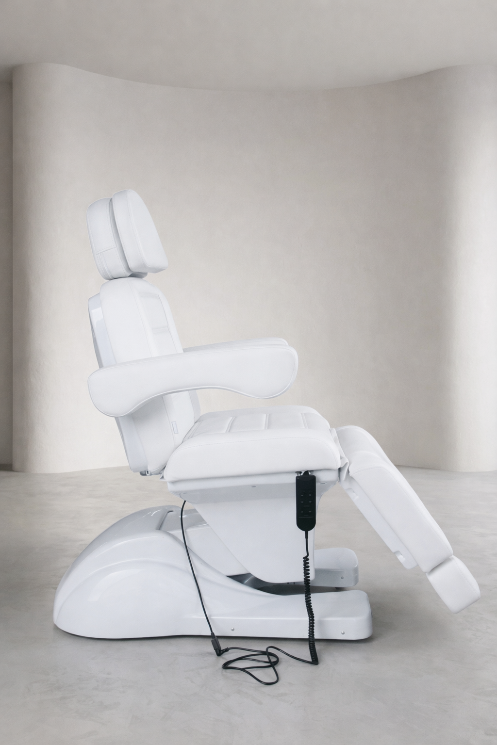 Professional electric facial bed with white padding, ergonomic armrests, and adjustable sections for beauty and medical treatments