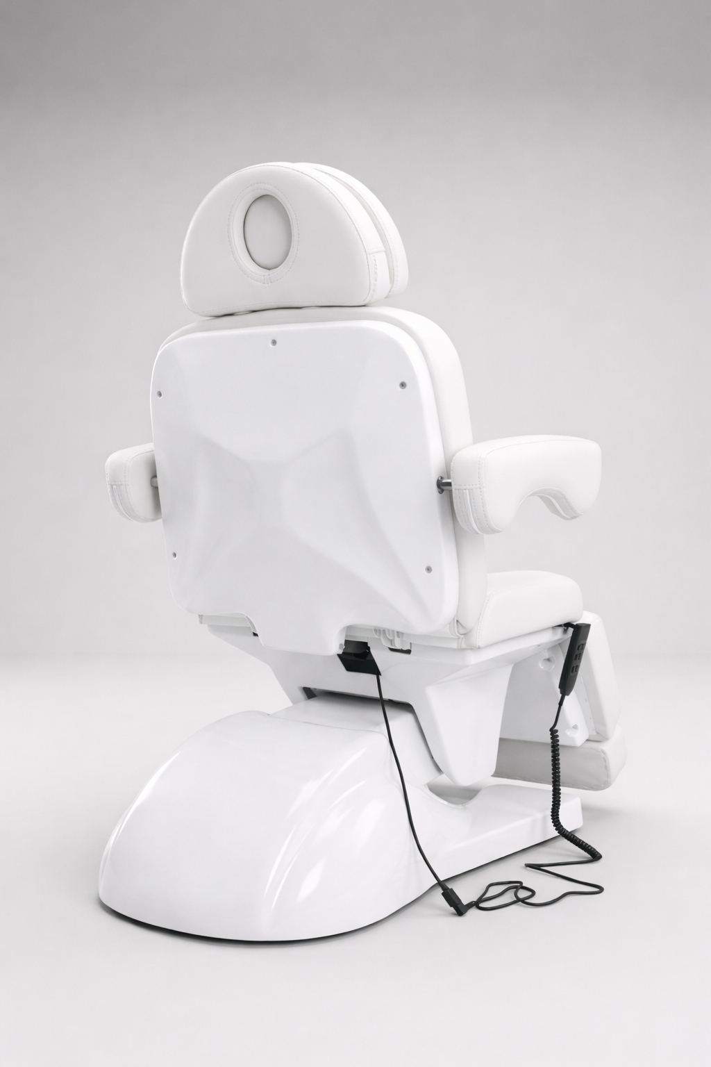 Adjustable beauty chair in crisp white vinyl with padded headrest and footrest, electric control for comfort and precision treatments