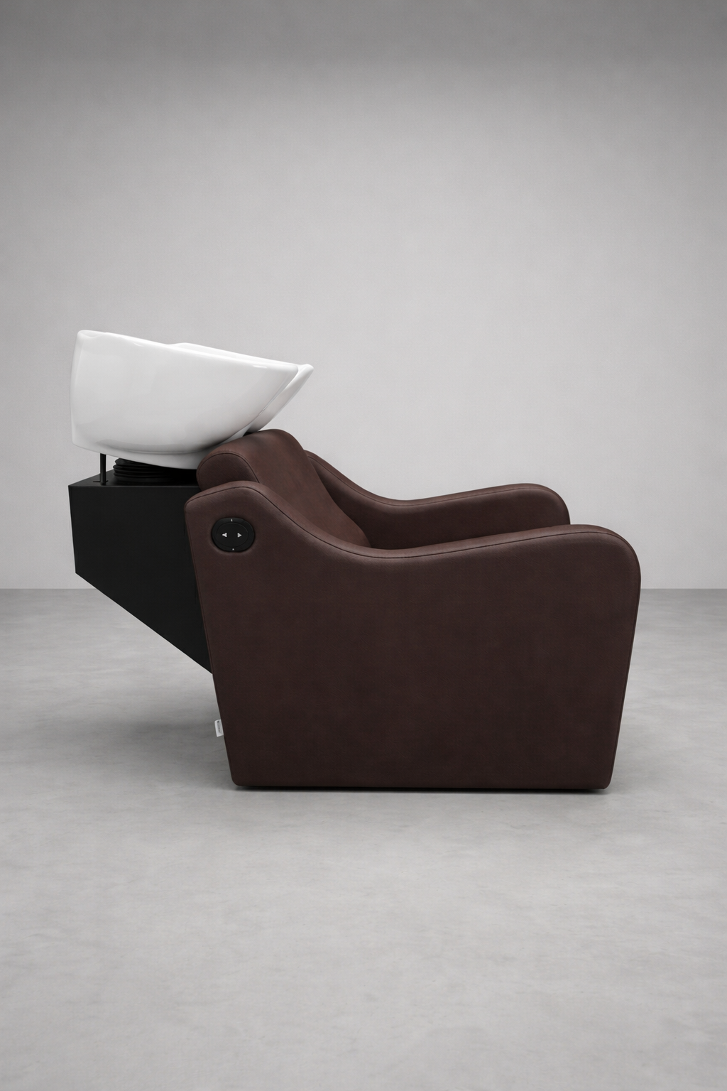 Contemporary salon backwash chair featuring chocolate vinyl cushioning, ergonomic recliner, and glossy white basin for hair washing