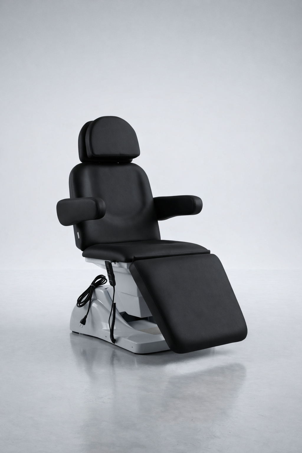 Professional cosmetic treatment chair in sleek black upholstery with motorised recline, suitable for injectables, skin treatments, and laser clinics