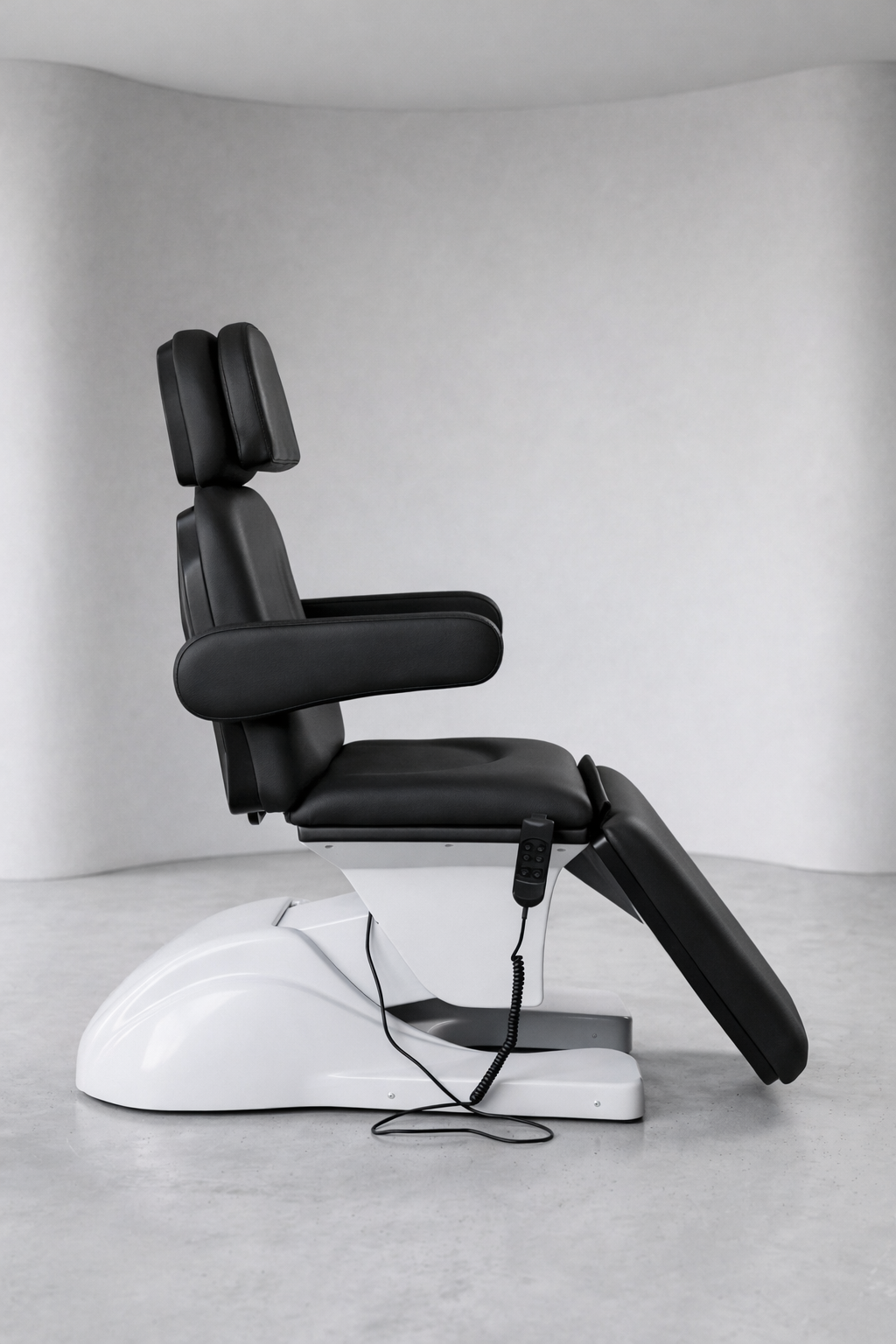 Commercial clinic treatment bed in black upholstery with reclining function and padded support for cosmetic, IPL, and laser treatments