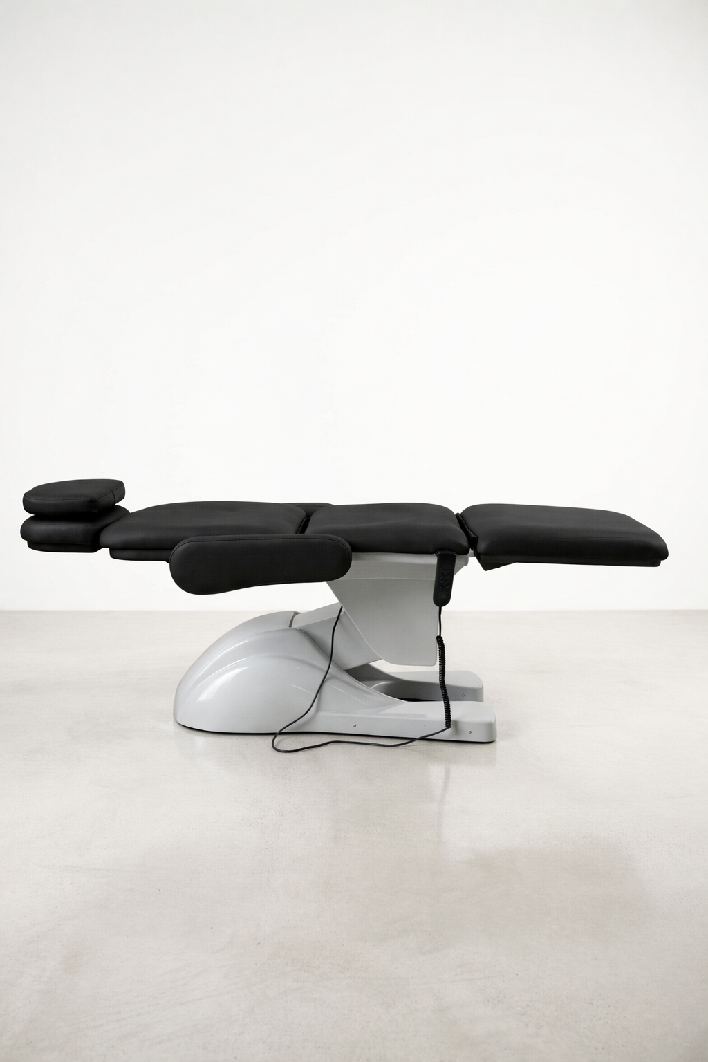 Cosmetic clinic chair with black vinyl upholstery, motorised adjustments, and ergonomic design for IPL, laser, and facial treatments